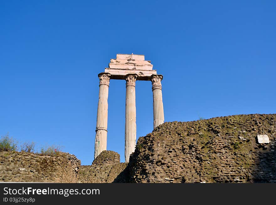 Ancient marble columns against a blue sky. Rome, Italy. Ancient marble columns against a blue sky. Rome, Italy