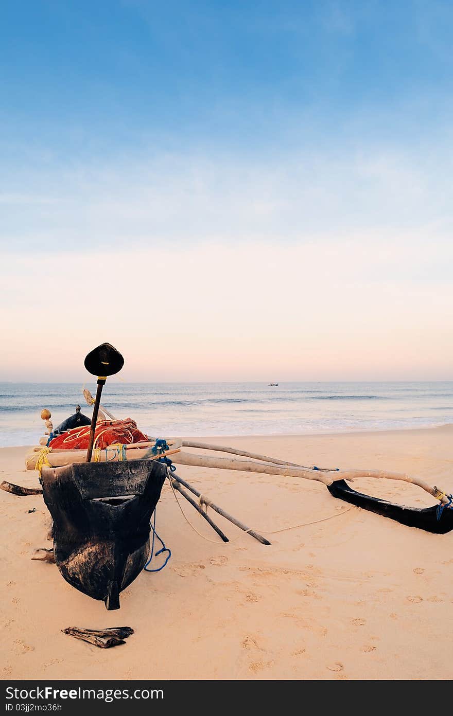 Old fishing boat on the lonely beach