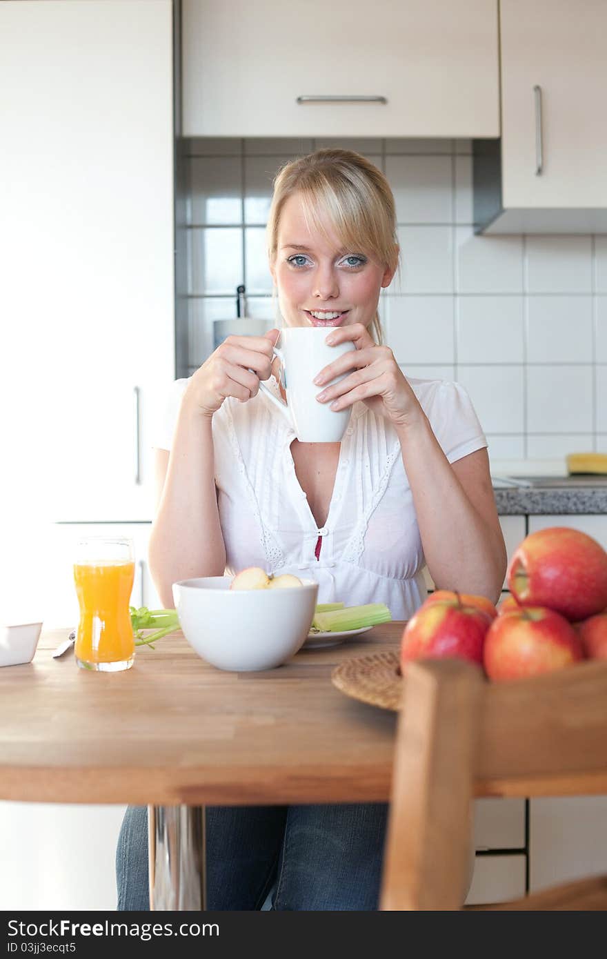 Young blond woman with her breakfast