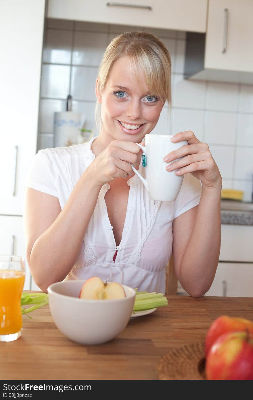 Young blond woman with her breakfast