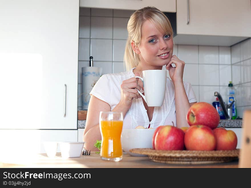 Young blond woman with her breakfast