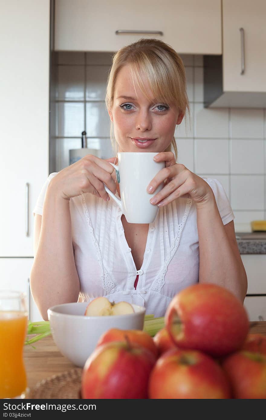 Young blond woman with her breakfast