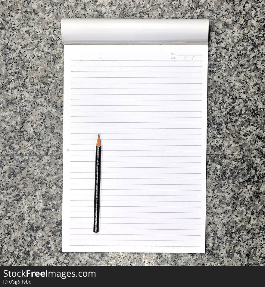 Blank open notebook and pencil