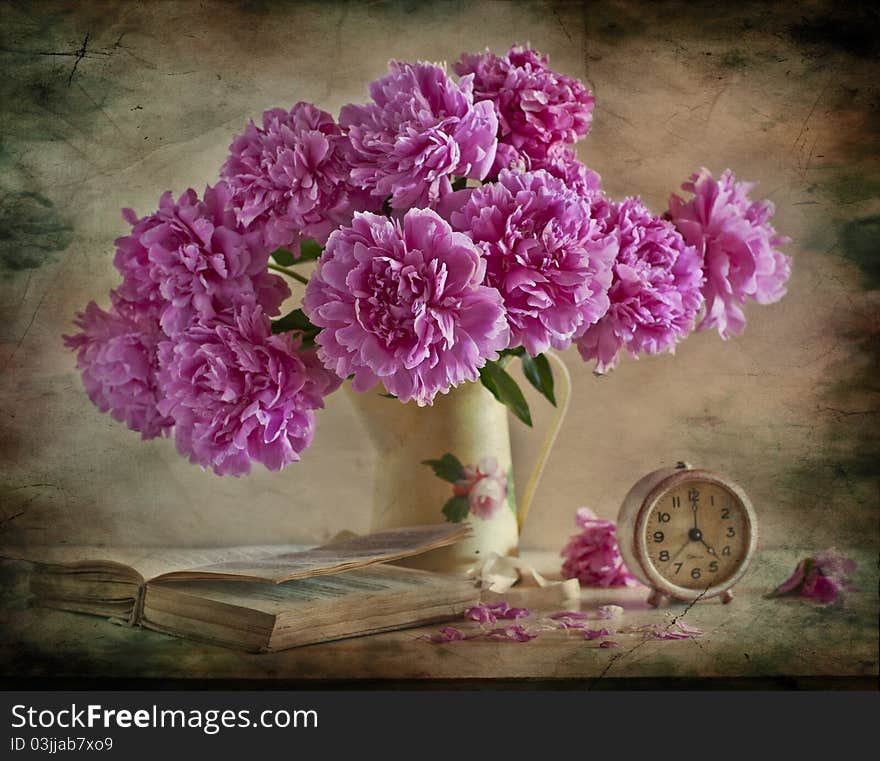 Bouquet of pi-mesons on a table, alongside book and clock