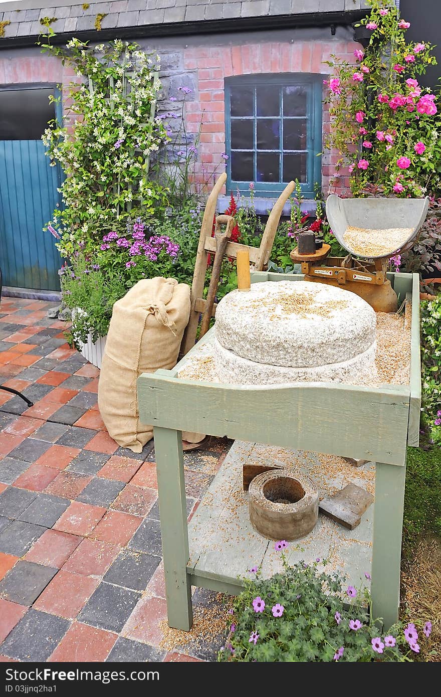 Old manual stone millstones in country village