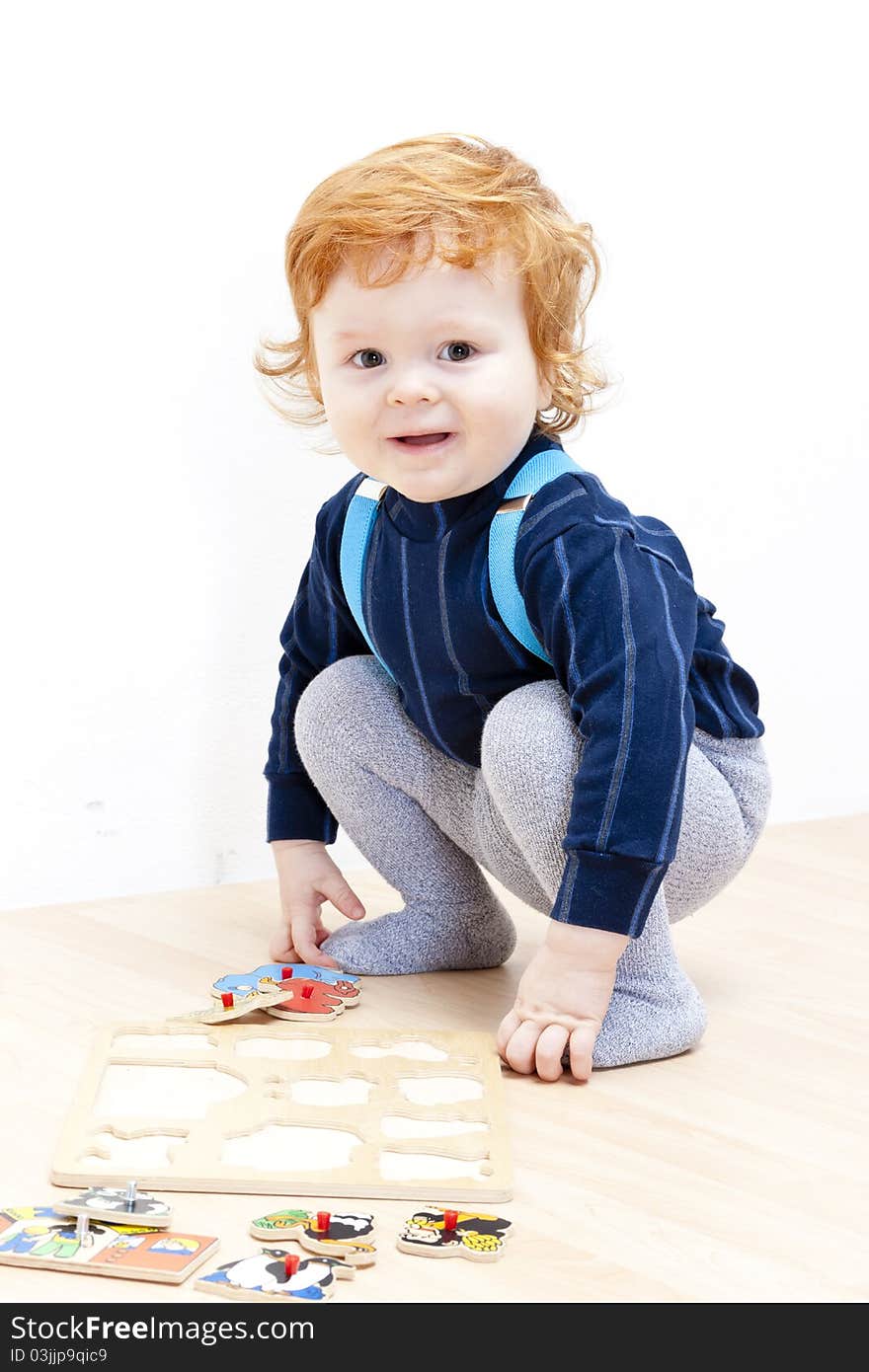 Little boy playing with puzzle