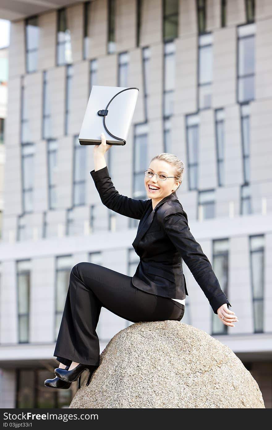 Sitting young businesswoman with a briefcase