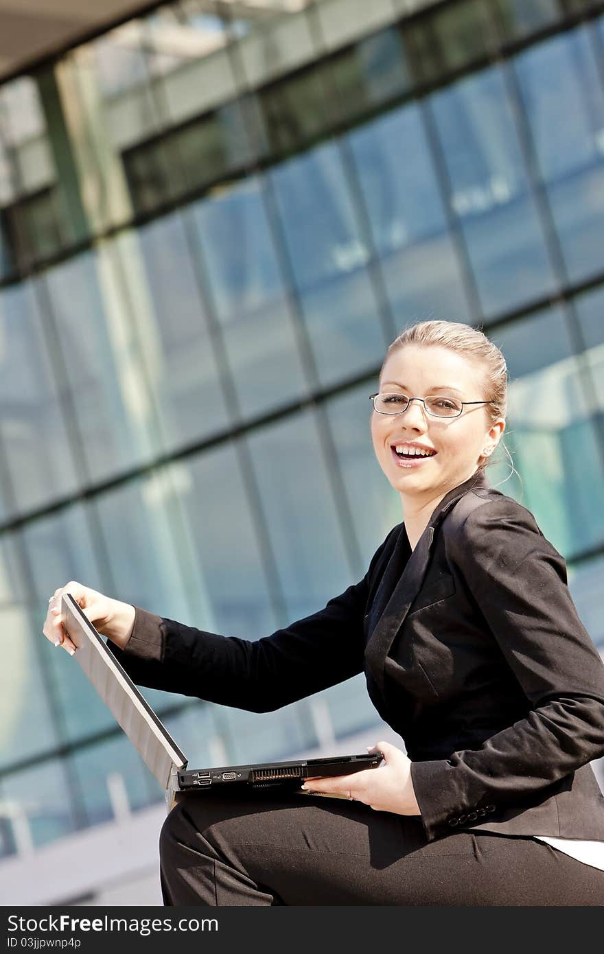 Sitting young businesswoman with a notebook