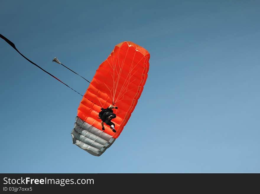 Parachutist descends fro a clear blue sky. Parachutist descends fro a clear blue sky