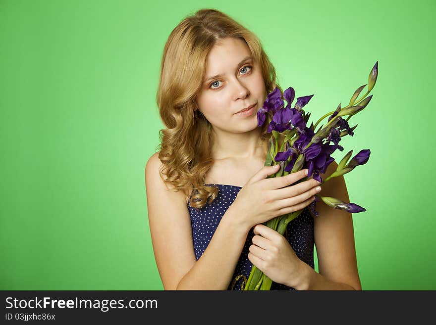 Attractive girl hugging a bouquet of Irises