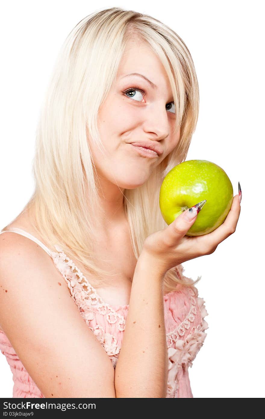 Beautiful blonde girl with fresh green apple in the reflection. Isolated on a white background