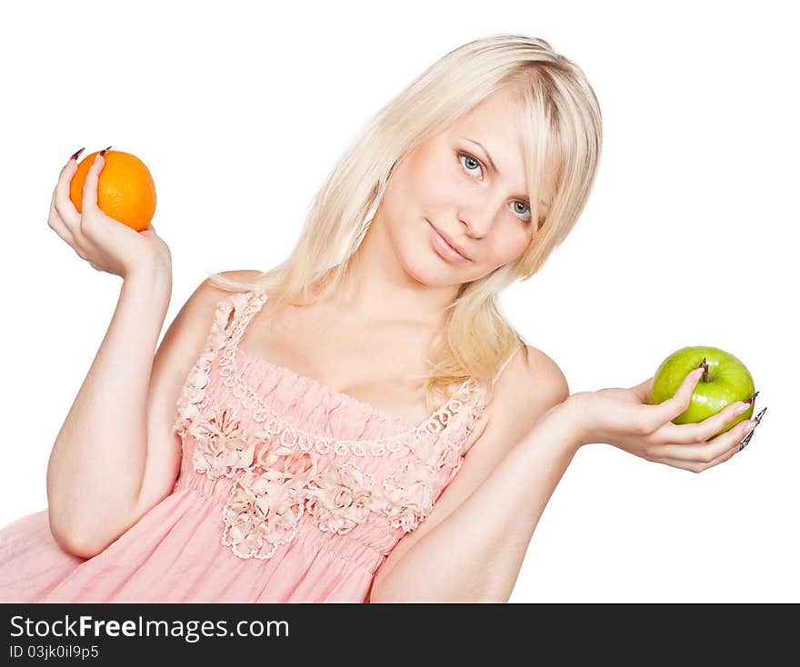 Young beautiful blonde girl choosing between apple and orange. Isolated on white background. Young beautiful blonde girl choosing between apple and orange. Isolated on white background