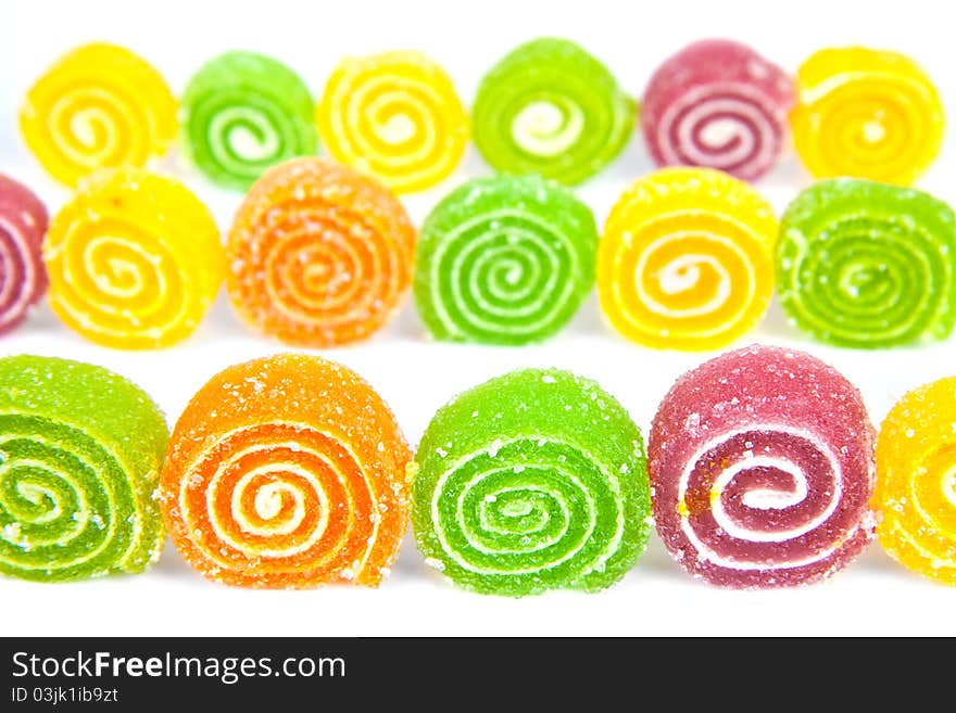 Colorful jelly in sugar on a white background