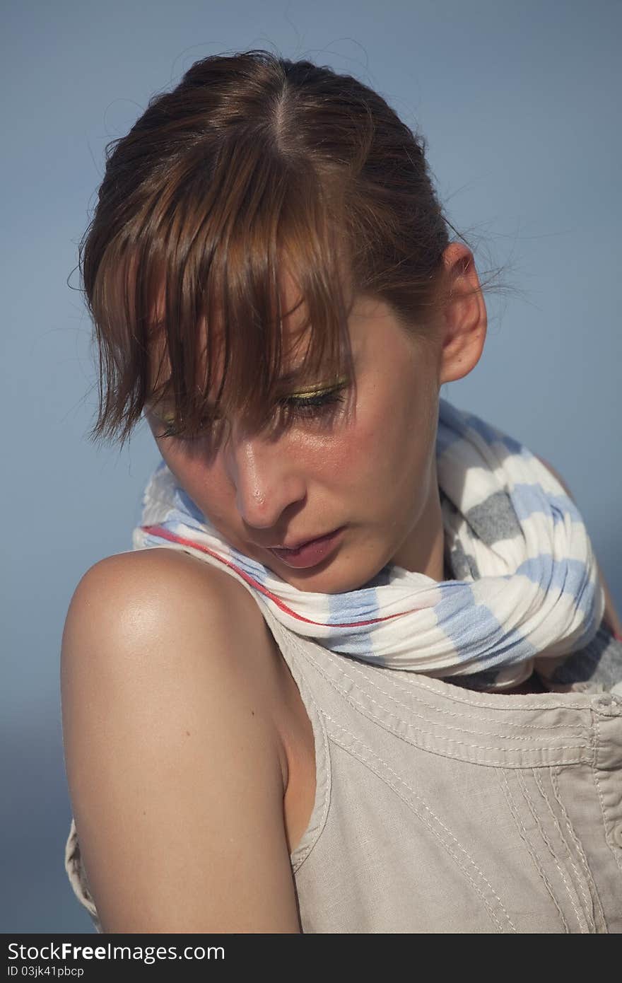 Portrait of sad woman over blue sky