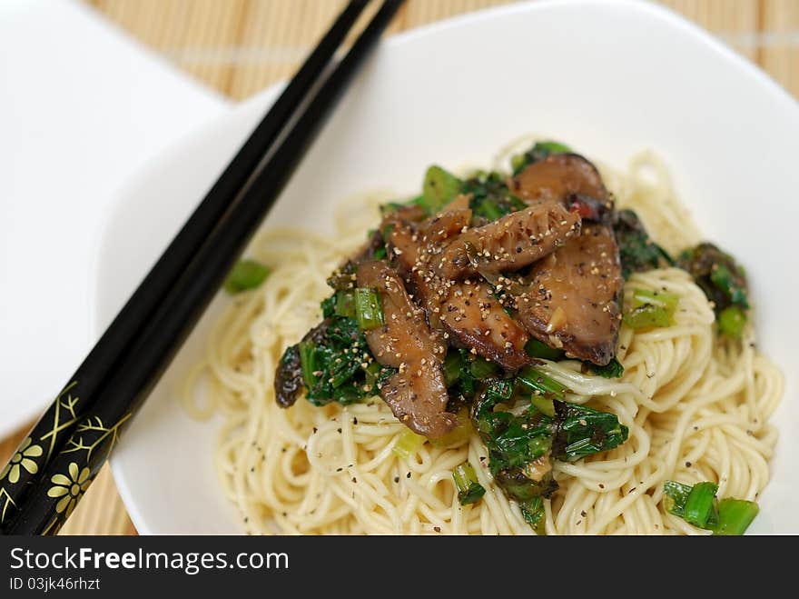 Oriental style mushroom noodles served with healthy ingredients. Oriental style mushroom noodles served with healthy ingredients.