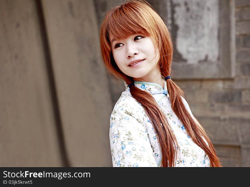 Chinese girl in traditional dress smiling outdoor. Chinese girl in traditional dress smiling outdoor.