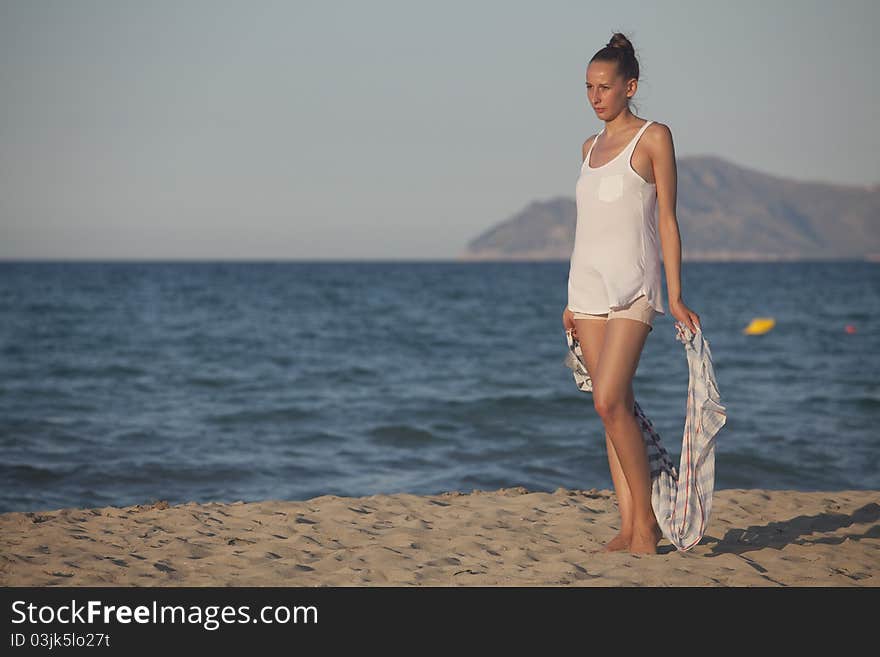 Woman with headscarf on the beach