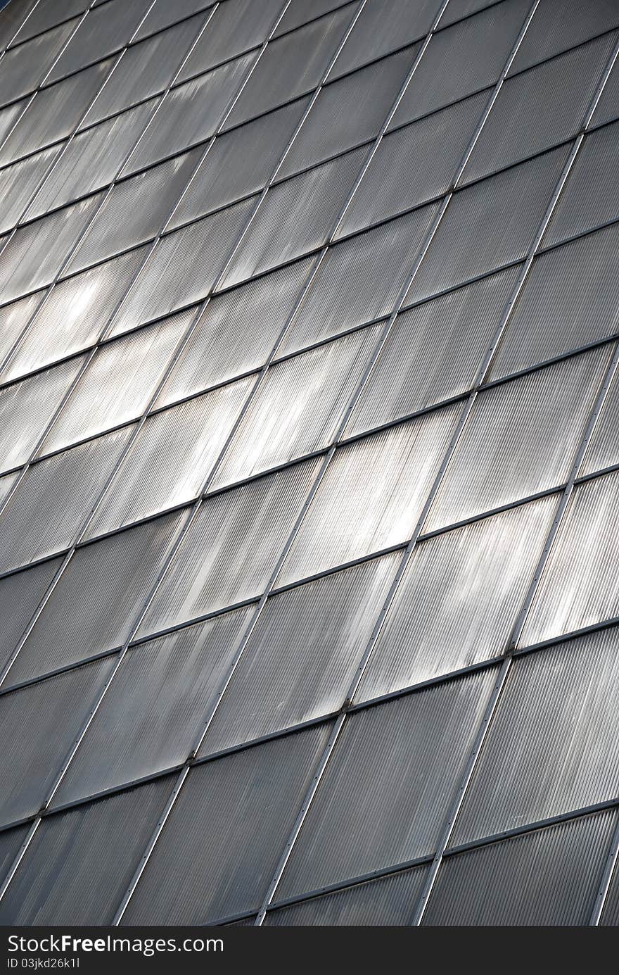 Gray glass wall of greenhouse with rhombic pattern