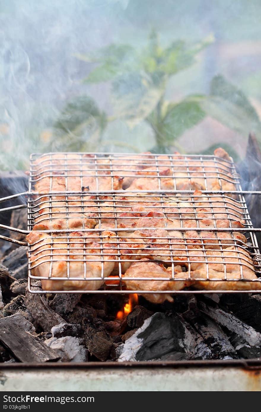 Cooking meat grilled on hot charcoal. Cooking meat grilled on hot charcoal