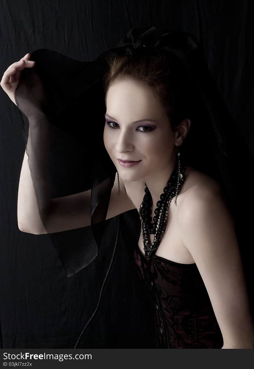 Portrait of beautiful woman in dark clothes