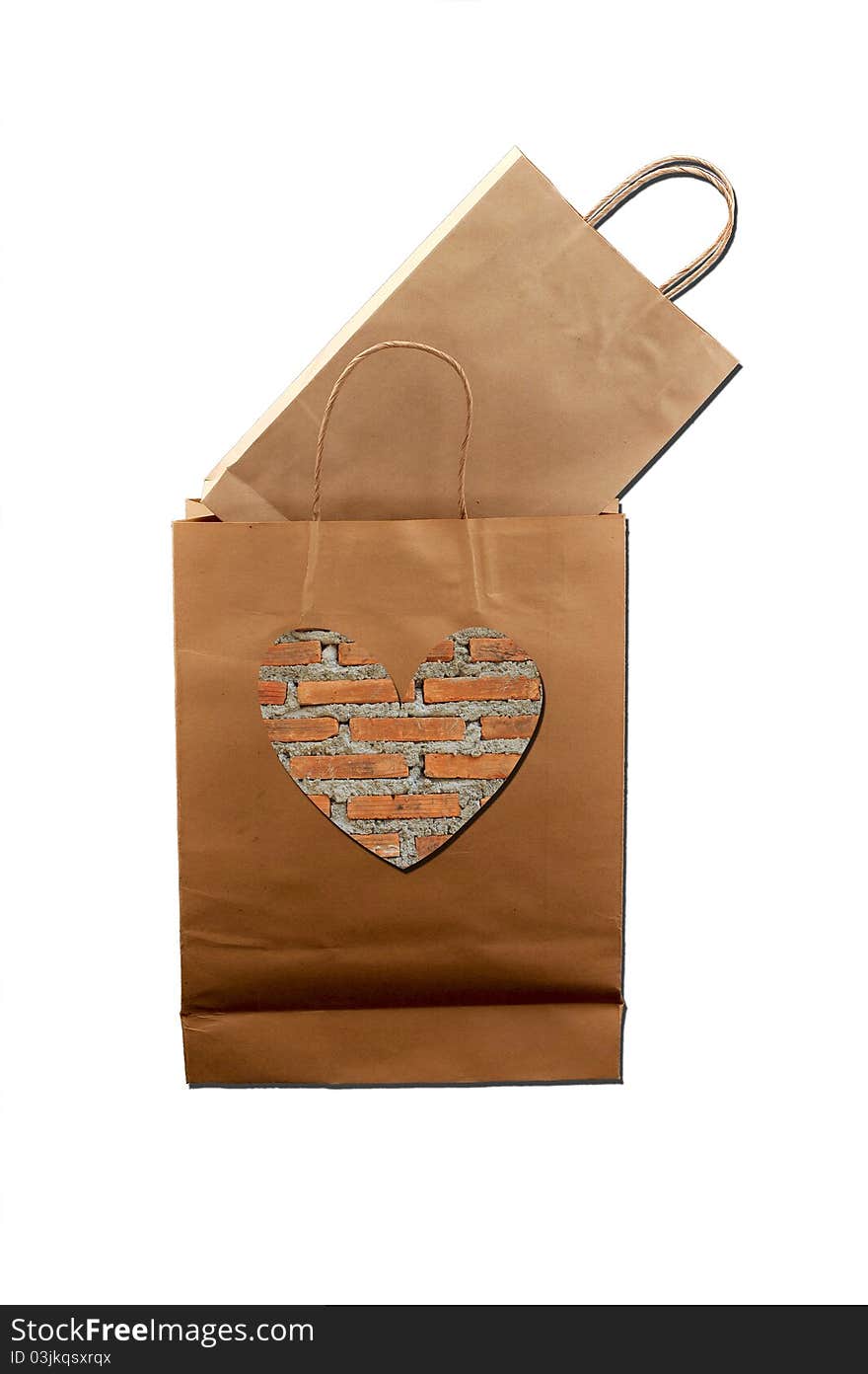 Brown paper bag with brick-pattern heart in the middle and another brown paper bag inside