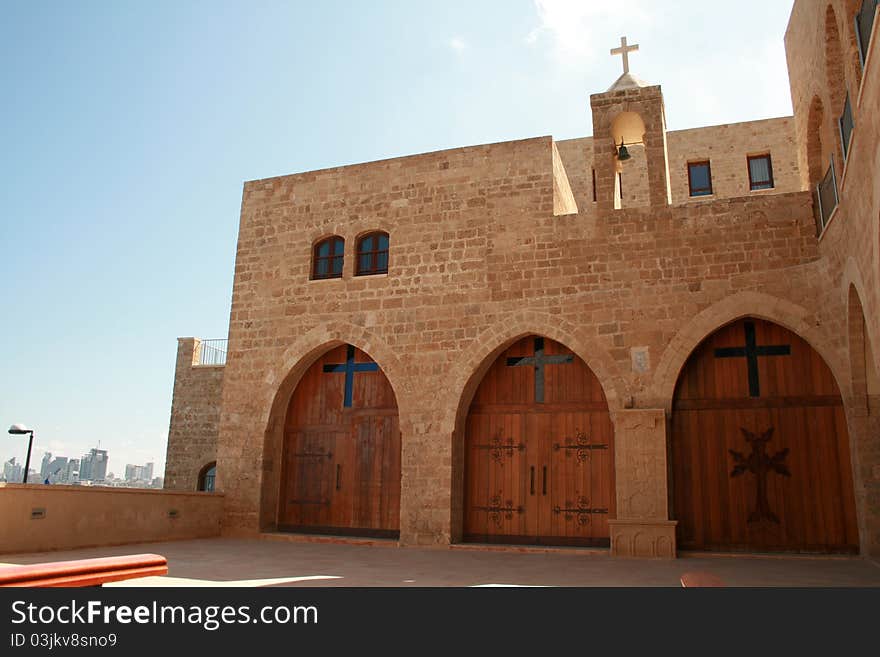 Entrance to the armenian christian monastery of Jaffo in Tel Aviv with the Mediterranean sea and Tel Aviv in background. Entrance to the armenian christian monastery of Jaffo in Tel Aviv with the Mediterranean sea and Tel Aviv in background.