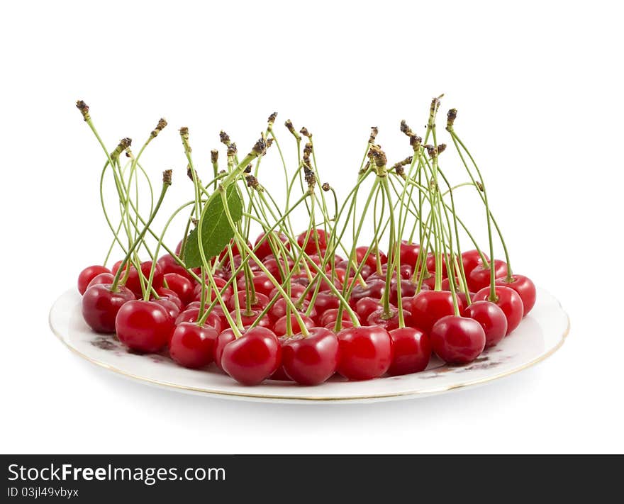 Cherry with a branch on a dish