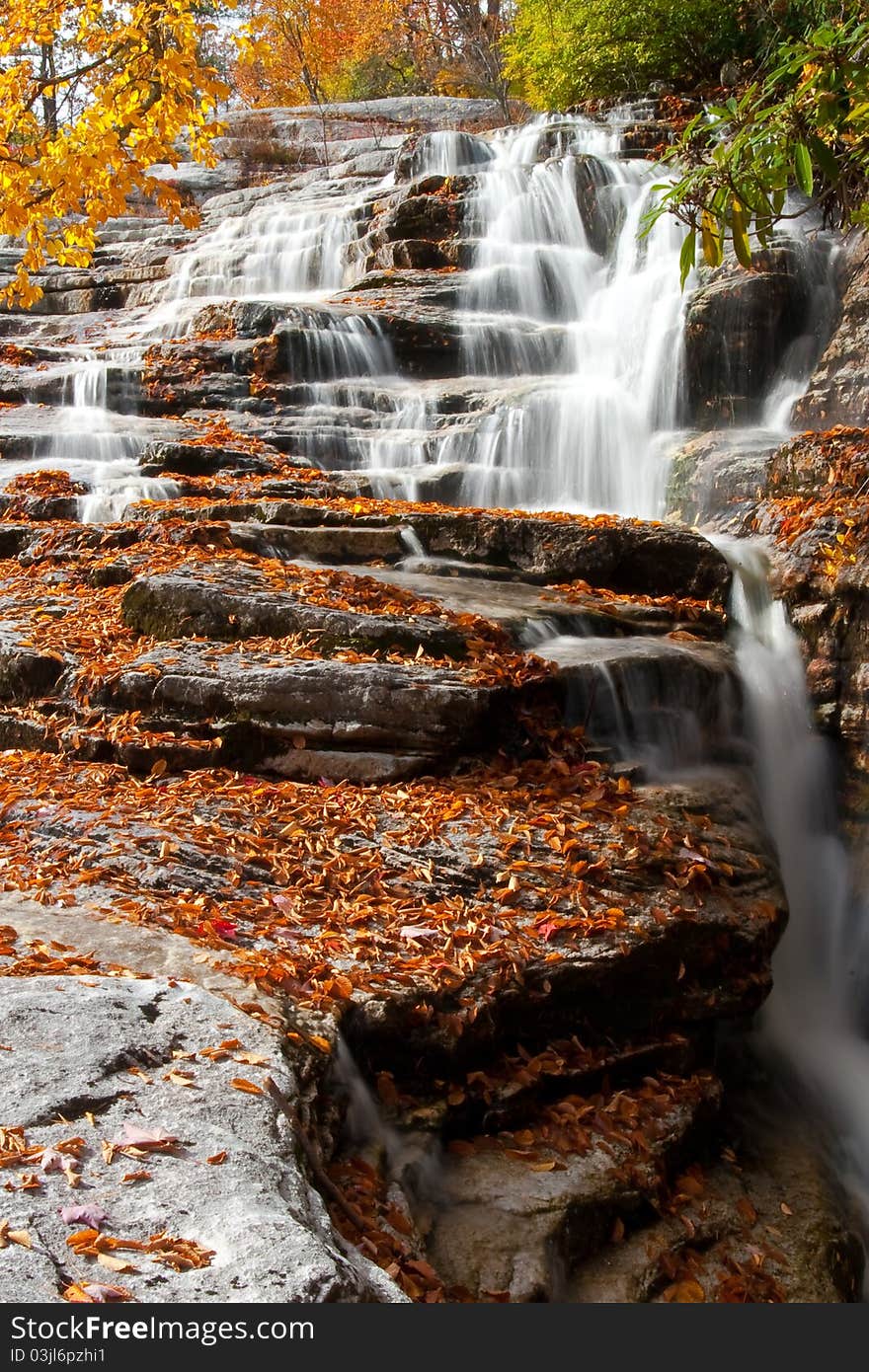 Northeasten waterfall cascading over fallen leaves. Northeasten waterfall cascading over fallen leaves.