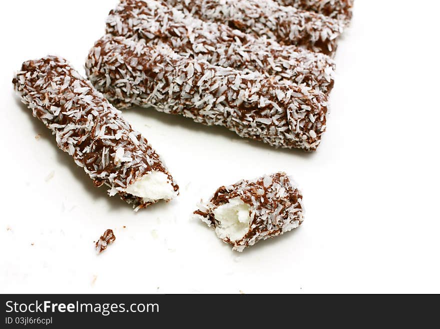 Sweet chocolate rolls with coconut close up. Sweet chocolate rolls with coconut close up