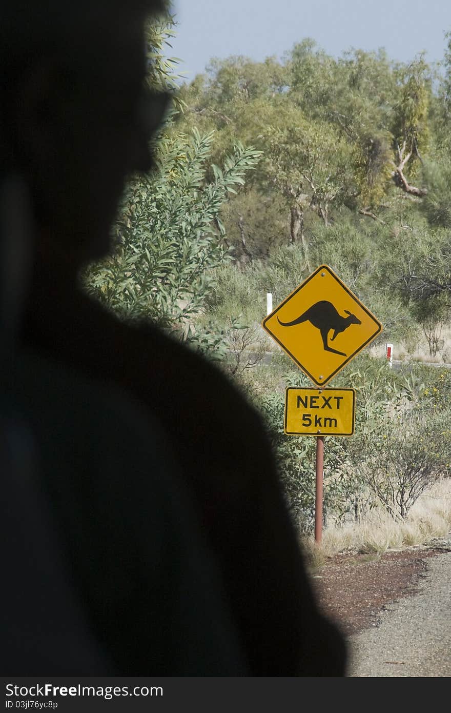 Traveler's view of warning sign for kangaroos in the Australian Outback. Traveler's view of warning sign for kangaroos in the Australian Outback