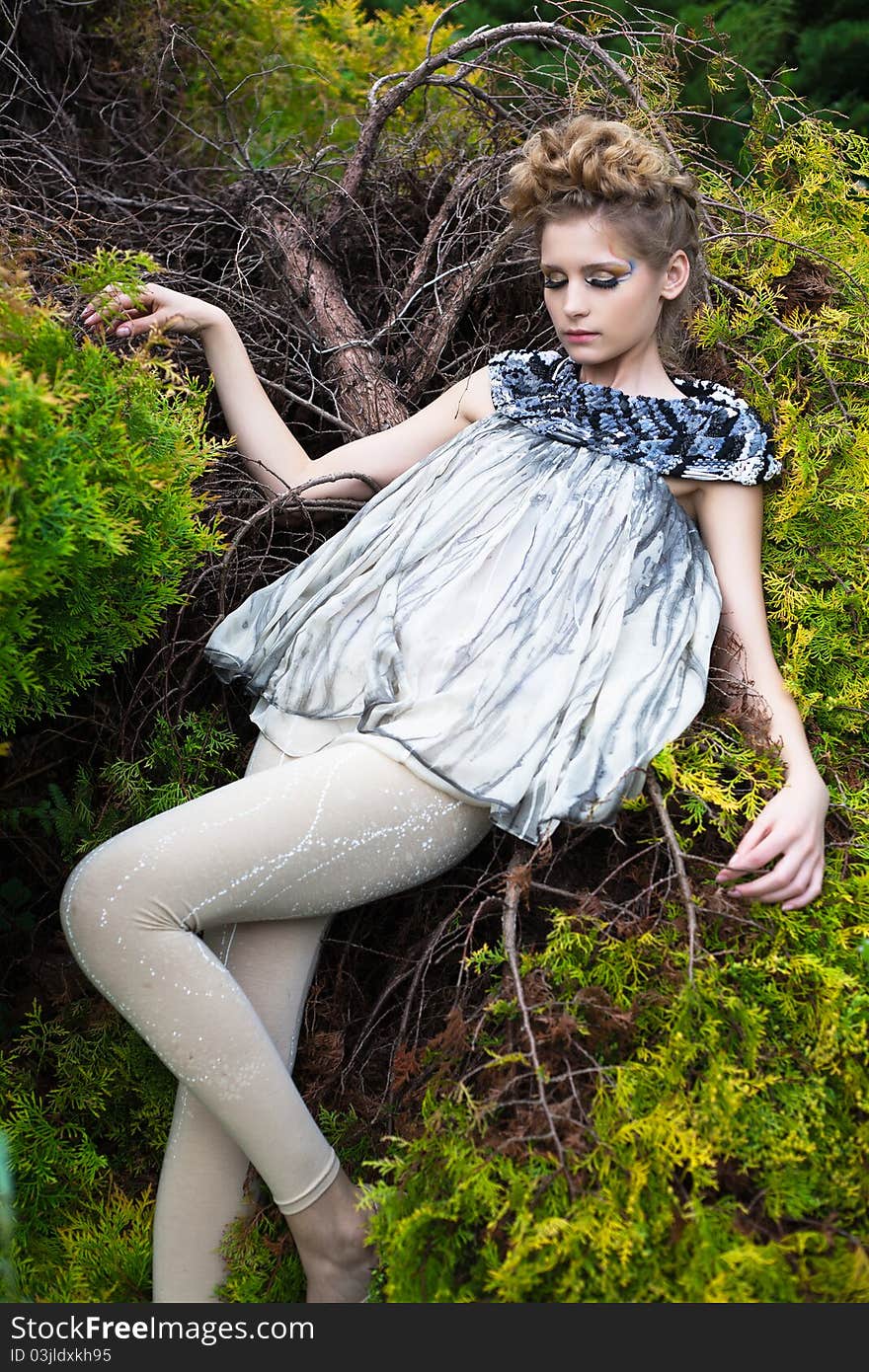 Portrait of a beautiful woman lying on a tree. Portrait of a beautiful woman lying on a tree