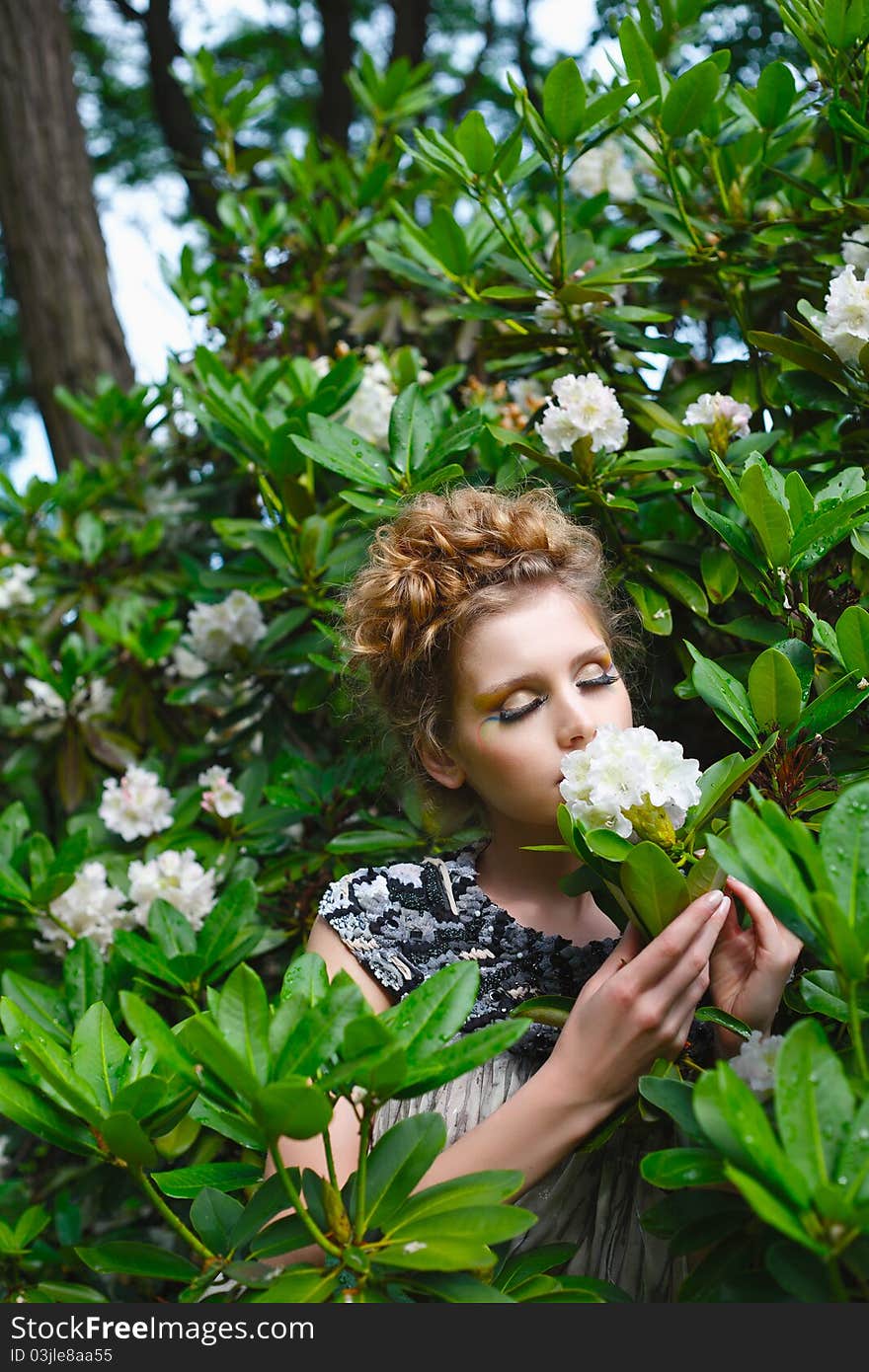 Portrait of a beautiful woman smelling flower. Portrait of a beautiful woman smelling flower