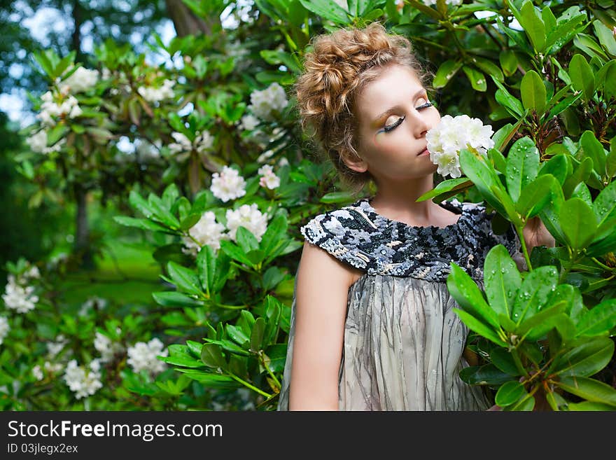 Portrait of a beautiful woman smelling flower. Portrait of a beautiful woman smelling flower