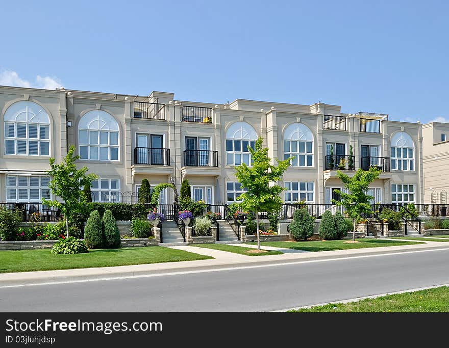 Modern Condominiums in urban setting under blue sky. Modern Condominiums in urban setting under blue sky