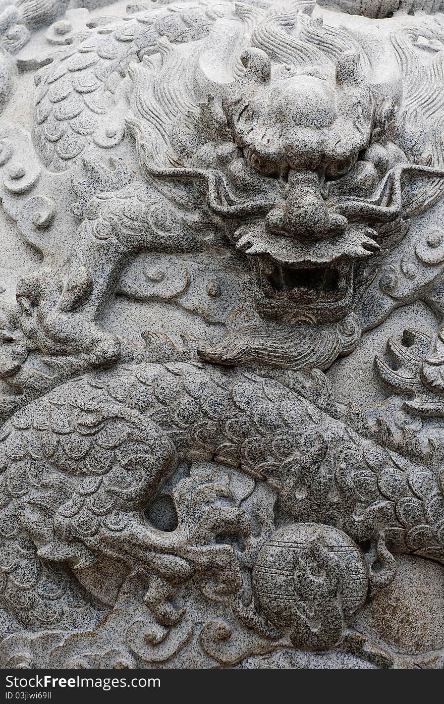 A stone carving with ancient Asian dragon theme. A stone carving with ancient Asian dragon theme