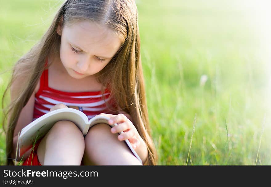 Girl with long hair, reading a book