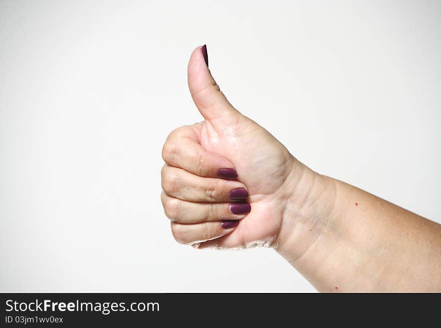 A woman's hand giving the thumbs up hand gesture.