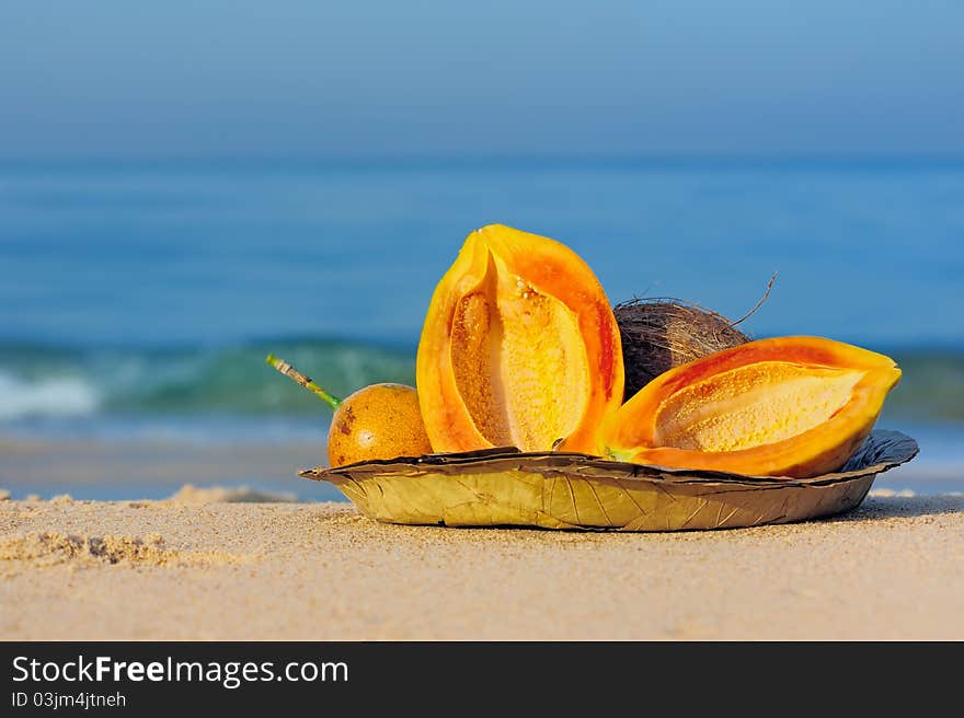 Exotic tropical fruit on the leaves plate on the sand. Exotic tropical fruit on the leaves plate on the sand