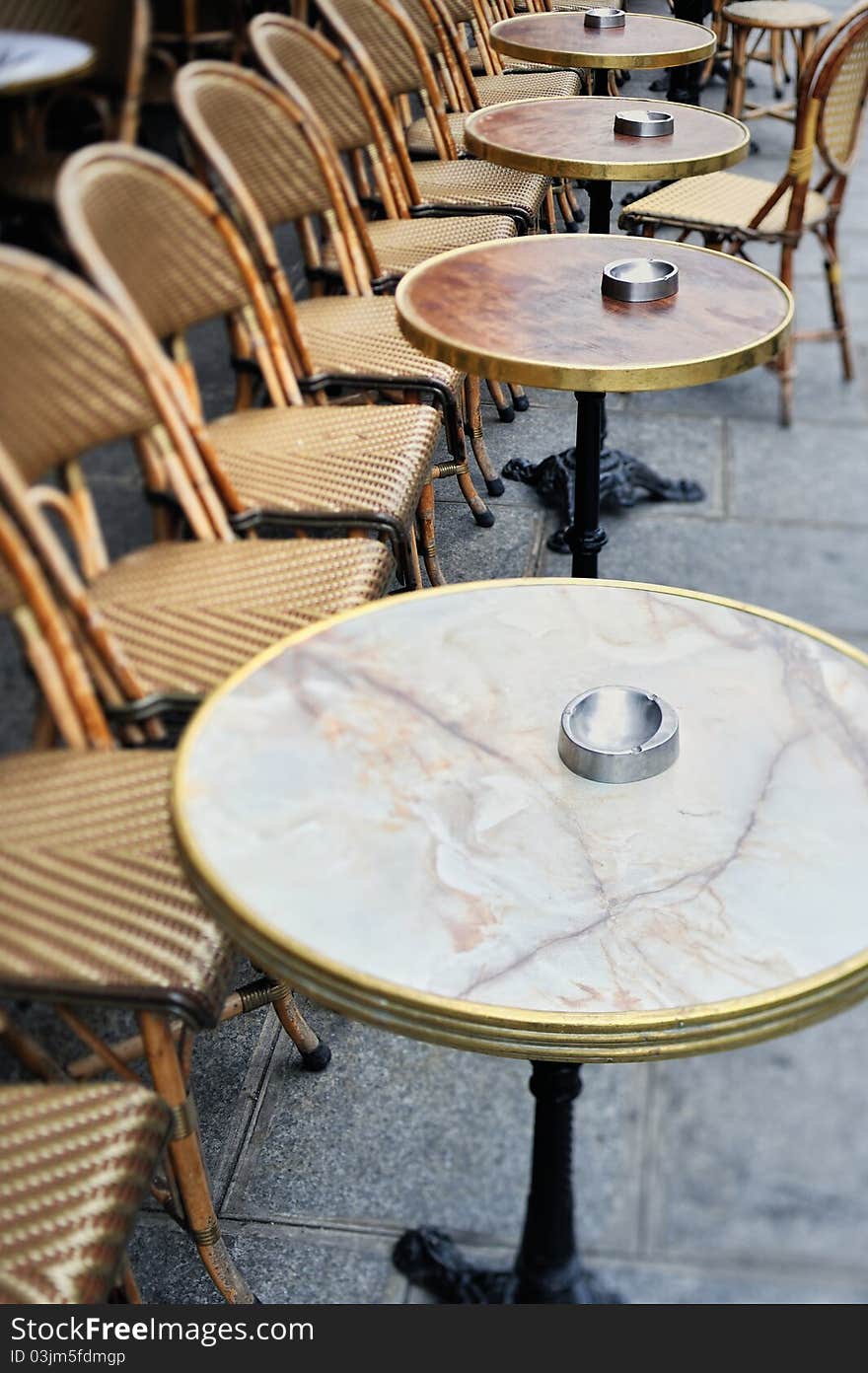 Round tables and chairs in cafe in Paris. Photo with tilt-shift effect. Round tables and chairs in cafe in Paris. Photo with tilt-shift effect