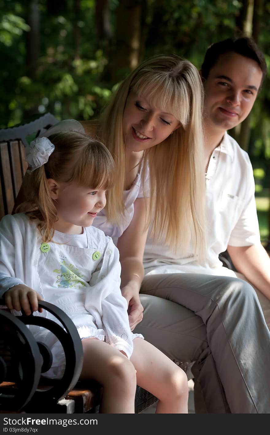 Family at park. Nice girl, mother and father