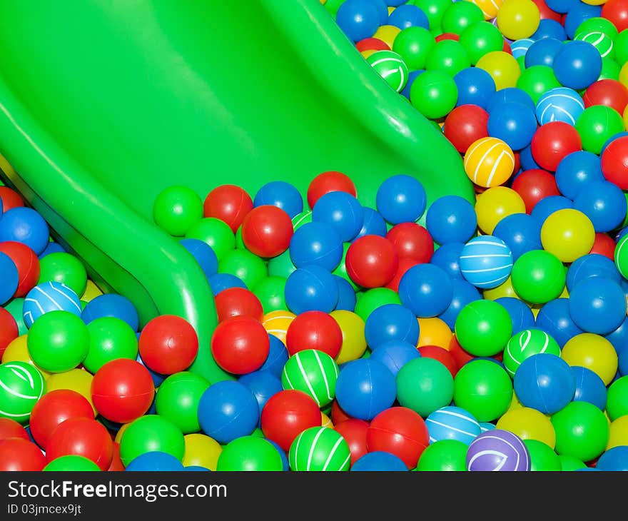 Playground slide and colorful plastic balls. Playground slide and colorful plastic balls