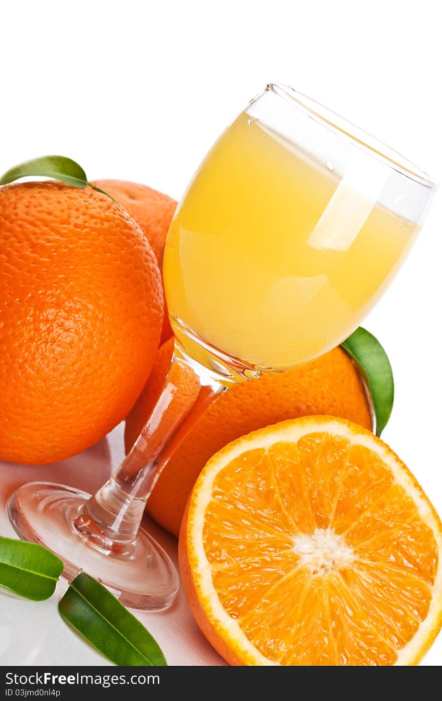 Orange juice in glass and fruits isolated on a white background