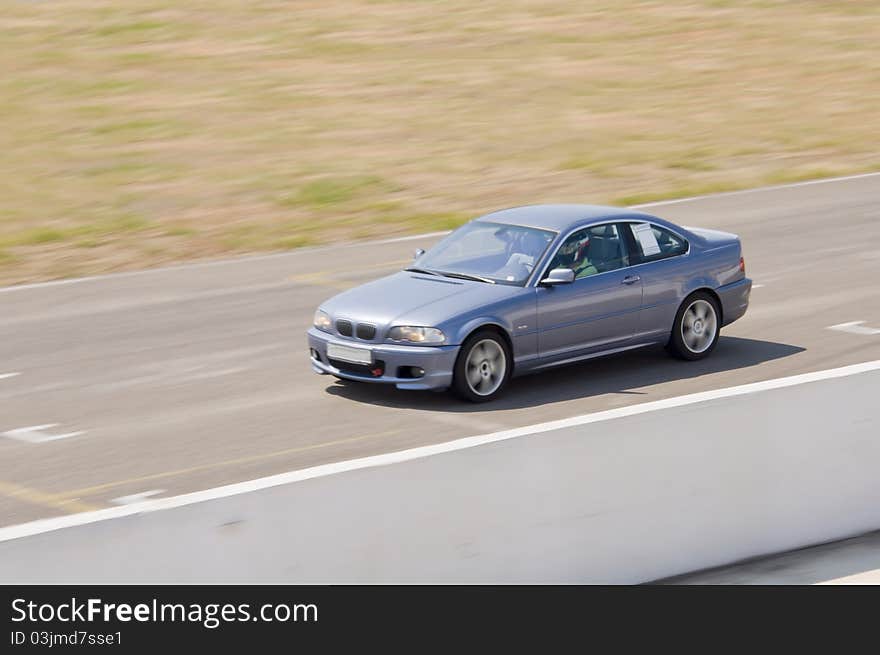 Fast grey car in a race. Fast grey car in a race