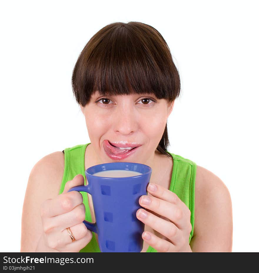 The girl drinks milk from a blue cup