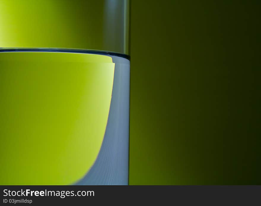 Pure water in glass with effect light on green background. Pure water in glass with effect light on green background