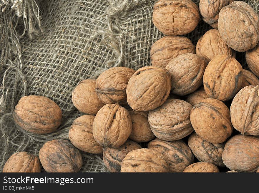 Walnuts on a background of rough cloth. Walnuts on a background of rough cloth