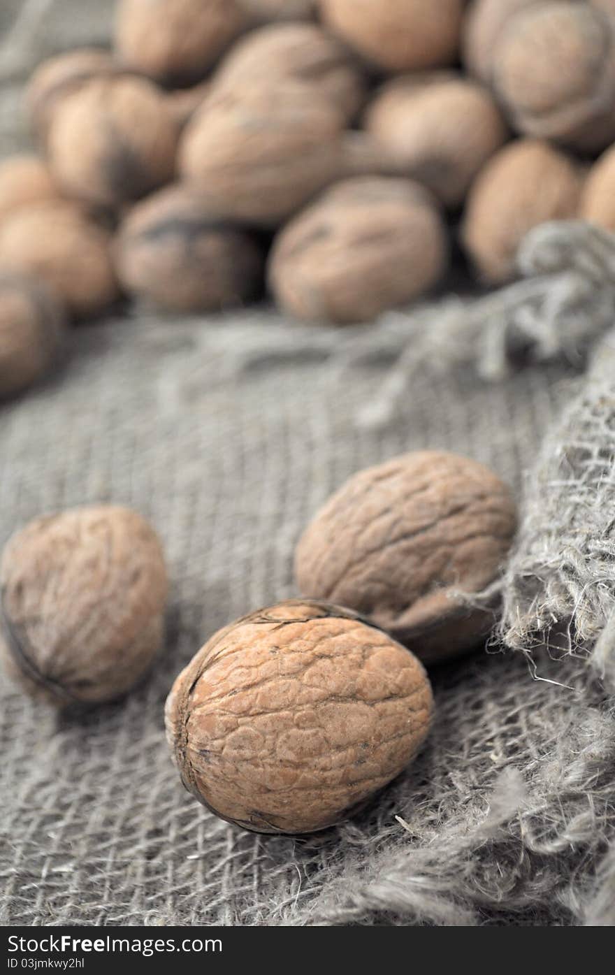 Walnuts on a background of rough cloth. Walnuts on a background of rough cloth