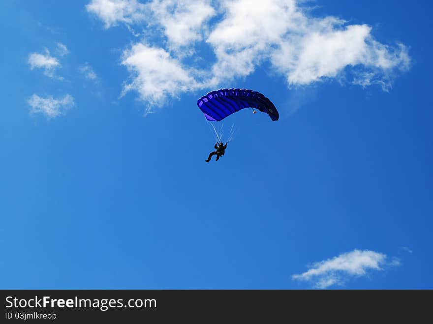 Man in blue baraglider on the sky. Man in blue baraglider on the sky