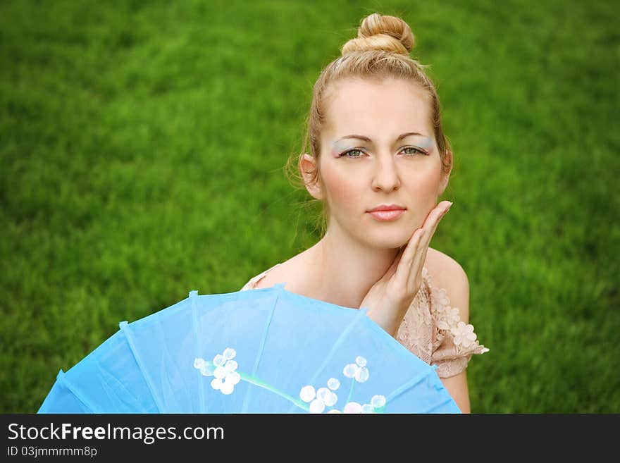 Beautiful blond girl with geisha make up outdoors