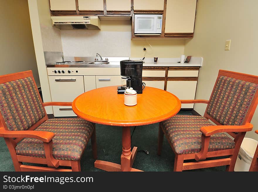 Table and chairs with drinks on table in the kitchen.